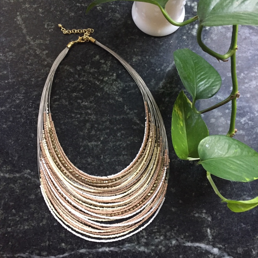 Bead necklace with gold tones, taupe and white.